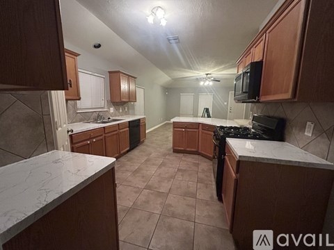 A kitchen with brown cabinets and a white counter top.
