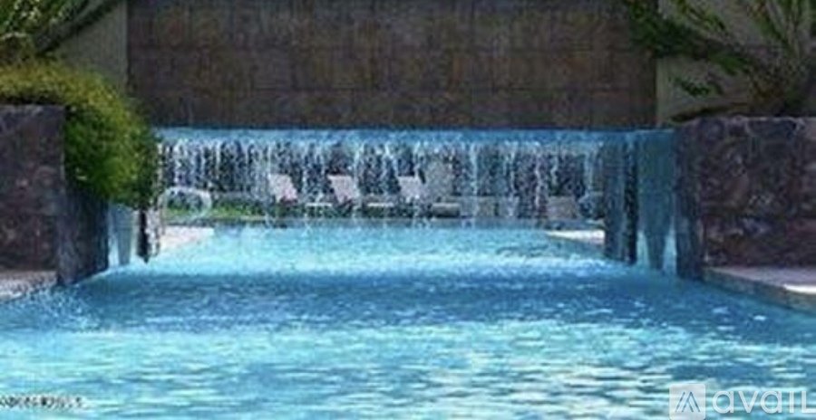 A pool with a waterfall feature in the middle.