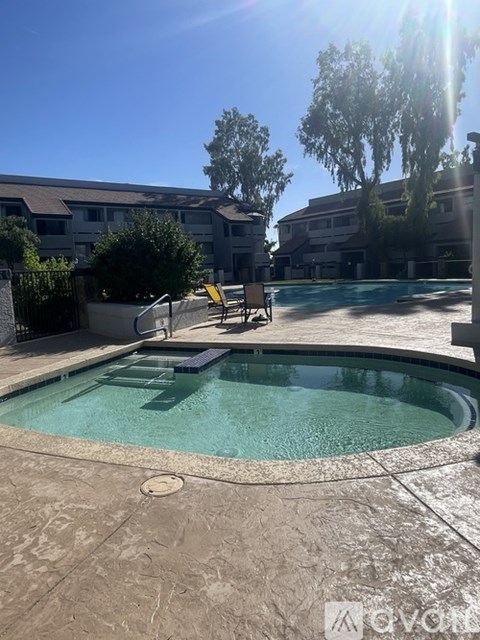 A pool with a waterfall feature in the middle.