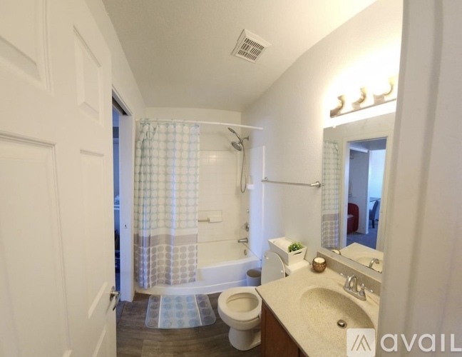 A bathroom with a toilet, sink, and shower.