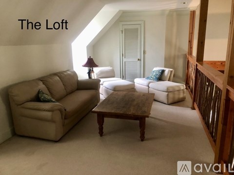 A living room with a tan couch and a wooden coffee table.