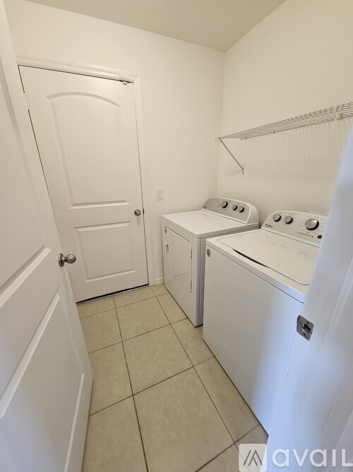 A small laundry room with a washer and dryer.