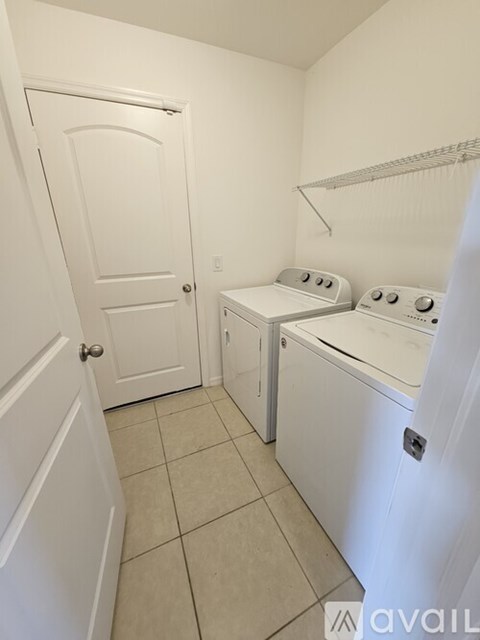 A small laundry room with a washer and dryer.
