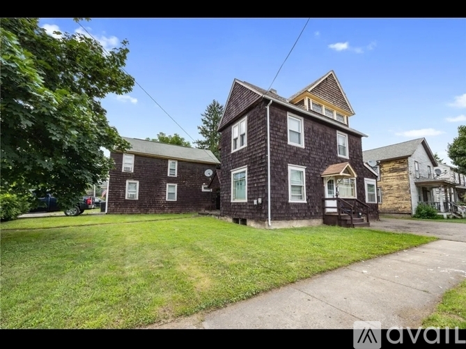 A house with a brown brick exterior is for sale.