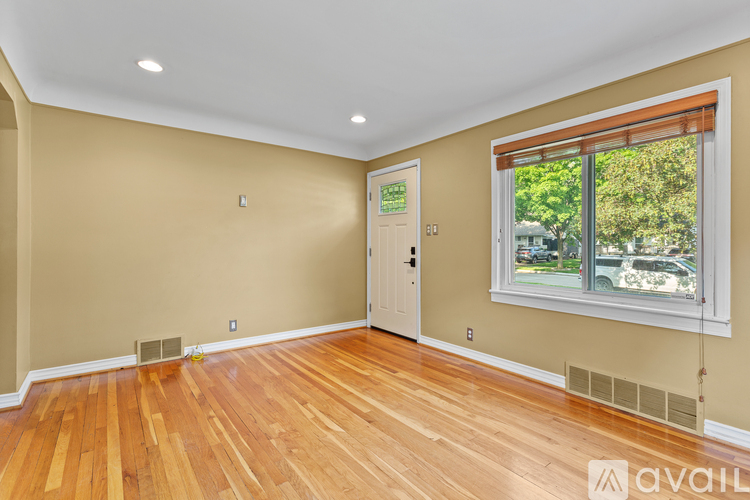 A house with a blue siding and a white door is for sale.