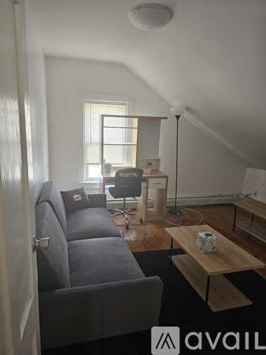 A living room with a grey couch and a wooden coffee table.