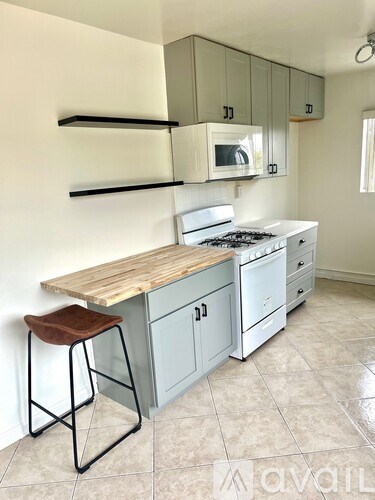 A kitchen with a white stove and a wooden counter.