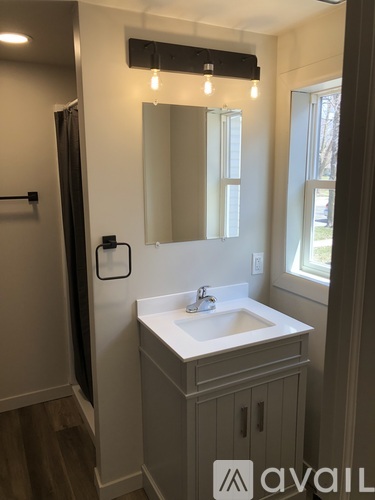 A bathroom with a sink and mirror.