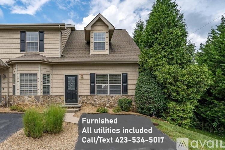 A house with a sign in front that says "Furnished All utilities included".
