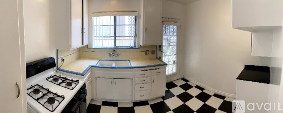 A black and white checkered floor in a kitchen.