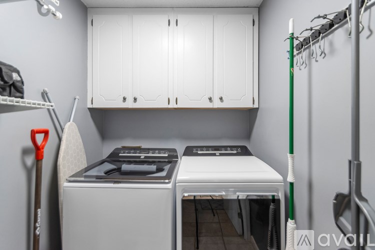 A small kitchen with a white oven and a white cabinet.