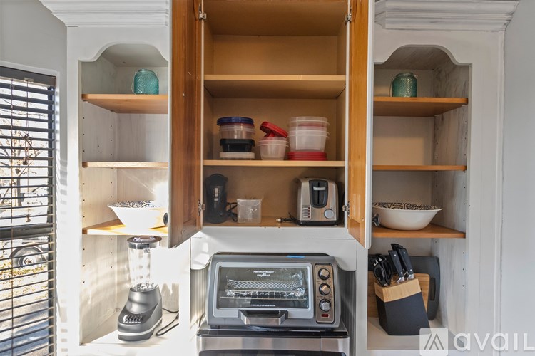 A kitchen with a toaster oven and a microwave on the counter.