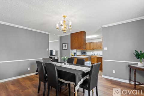 A dining room with a table set for four.