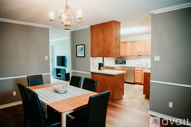 A dining room with a table set for four.