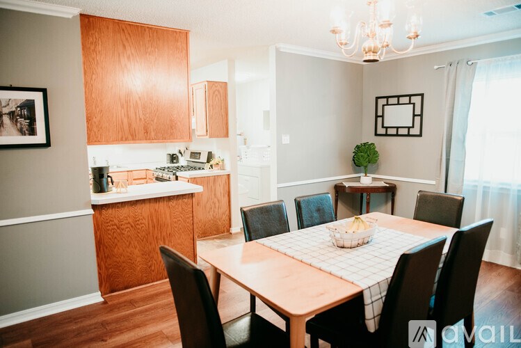 A kitchen with a dining table and chairs.