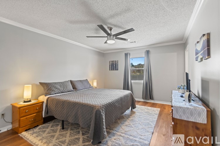 A wooden desk with a chair and a box on it.