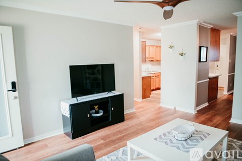 A living room with a television and a coffee table.