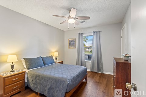 A bedroom with a bed and a window.