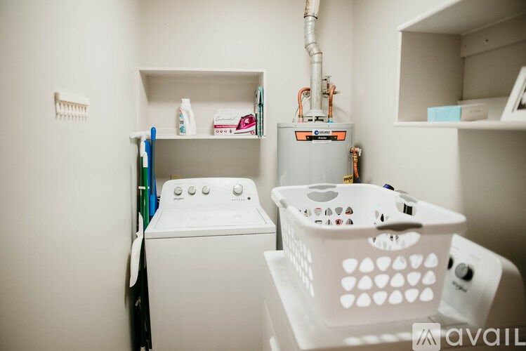 A white washing machine and dryer in a small laundry room.