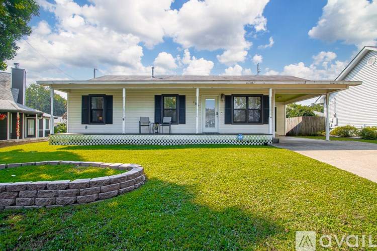 A house with a white exterior and black shutters is for sale.