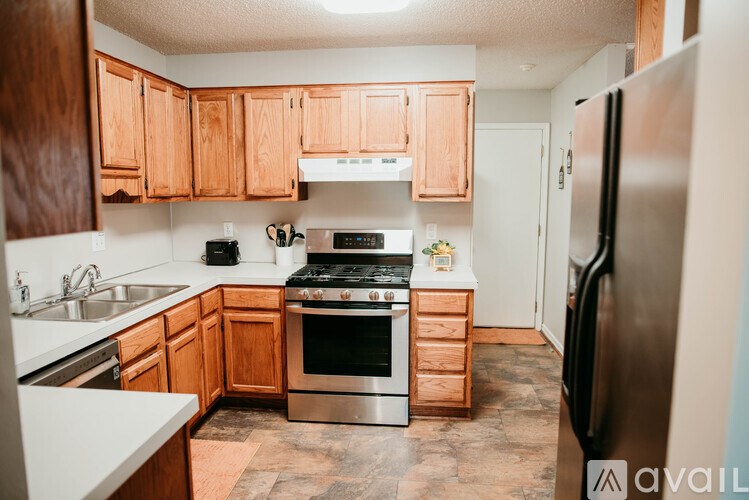 A kitchen with wooden cabinets and stainless steel appliances.