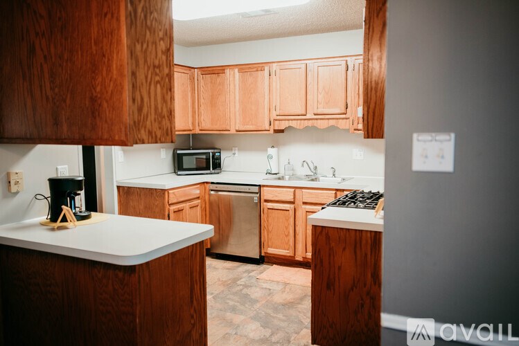 A kitchen with wooden cabinets and a white countertop.