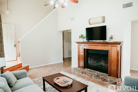 A living room with a fireplace and a television above it.