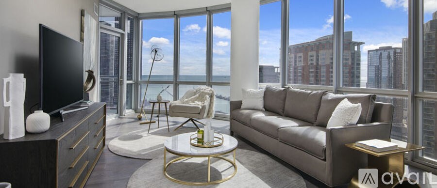 A living room with a large window overlooking the city.