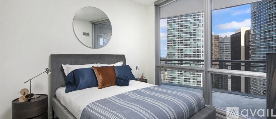 A bedroom with a large bed and a view of the city.