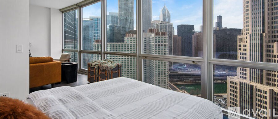 A bedroom with a large bed and a view of the city.