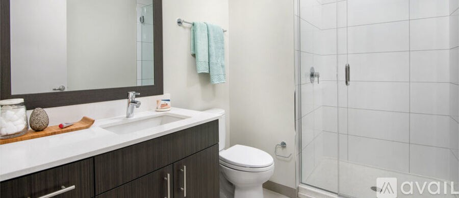 A bathroom with a toilet, sink, and shower.