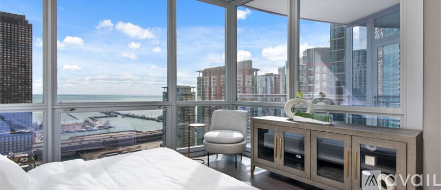 A bedroom with a large bed and a view of the city.