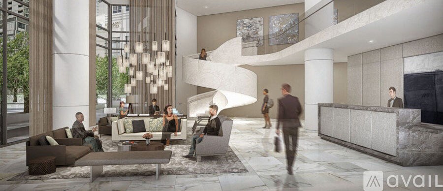 A modern lobby with people walking and sitting.