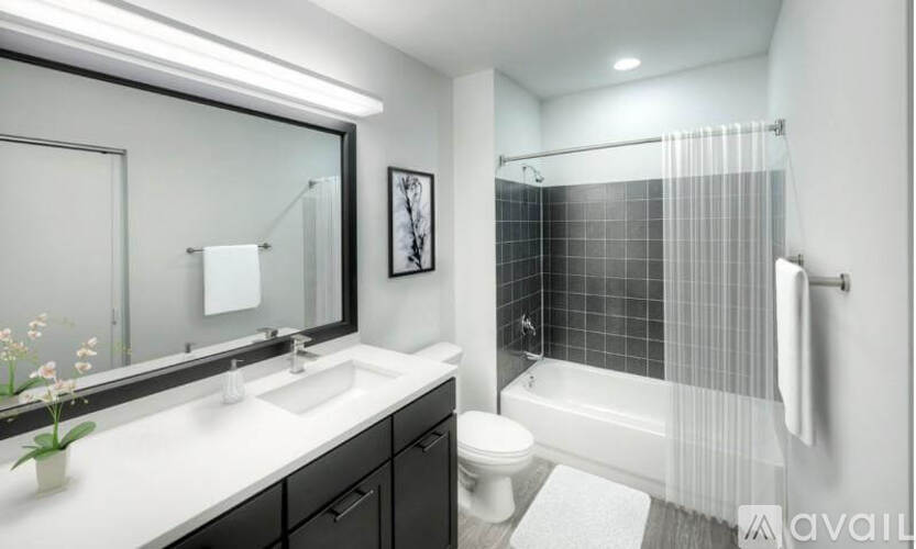 A bathroom with a white sink, a toilet, and a shower with a glass door.