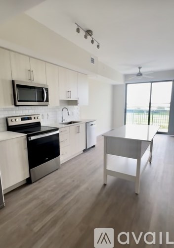 A modern kitchen with a black microwave above the stove.