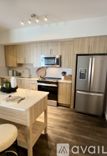 A kitchen with wooden cabinets and a white island.