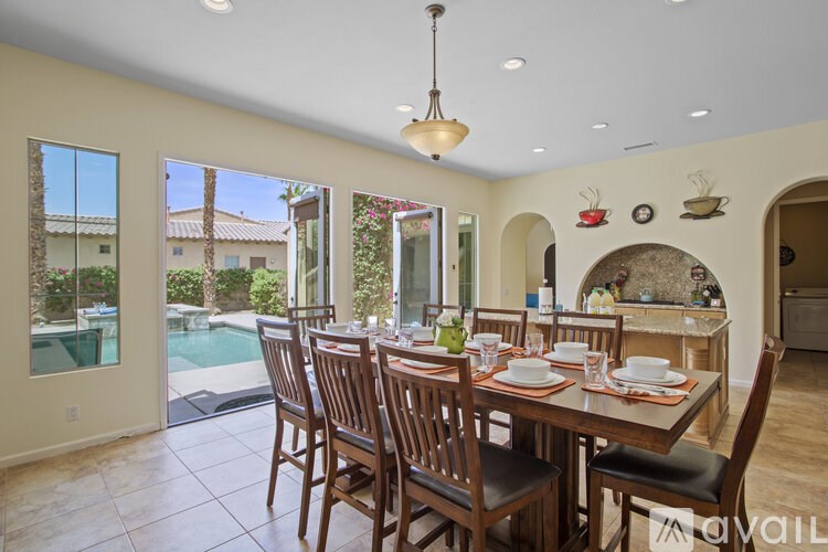 A dining room with a table set for six.