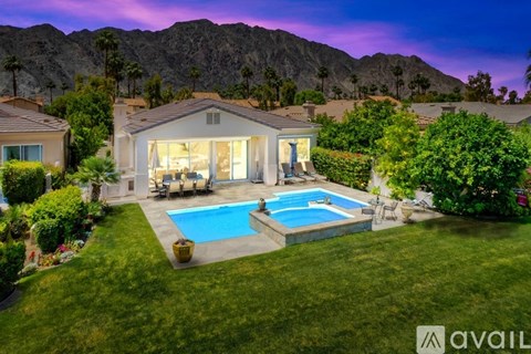 A house with a pool in the backyard.