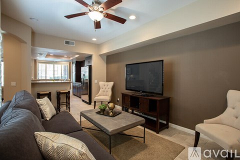 A living room with a television and a couch.