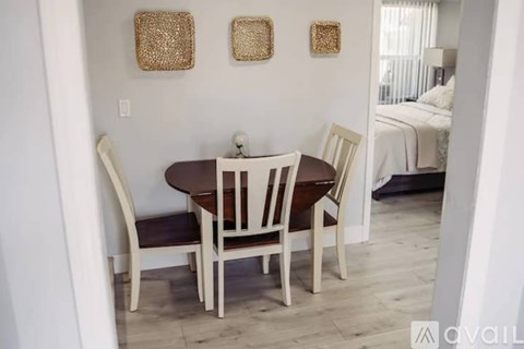 A dining room with a table and chairs.