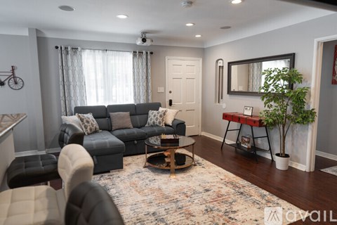 A living room with a grey sofa and a coffee table.