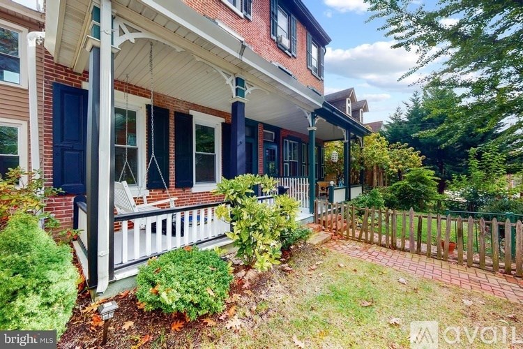 A house with a porch and a fence.