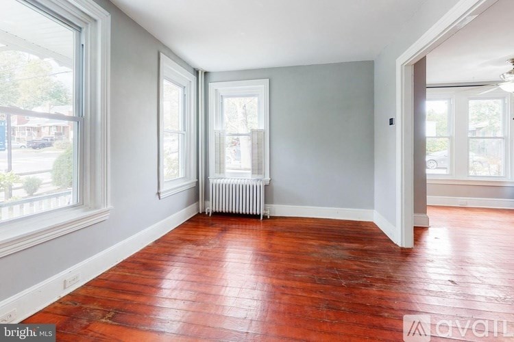 A room with wooden floors and white walls.