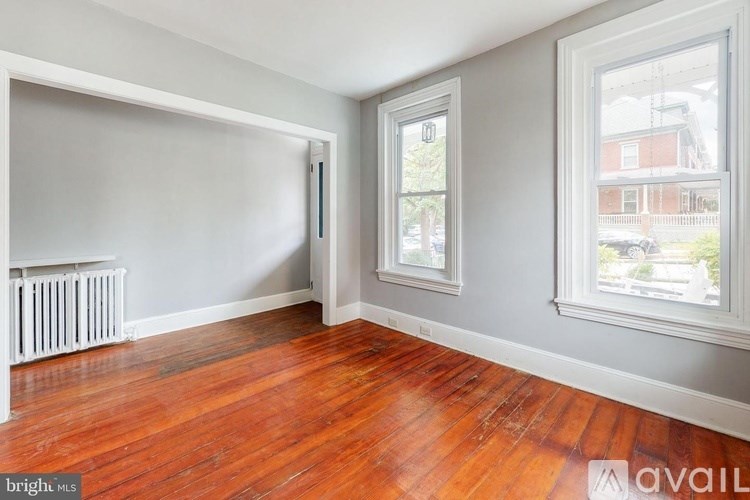 A room with a window and a radiator on the wall.