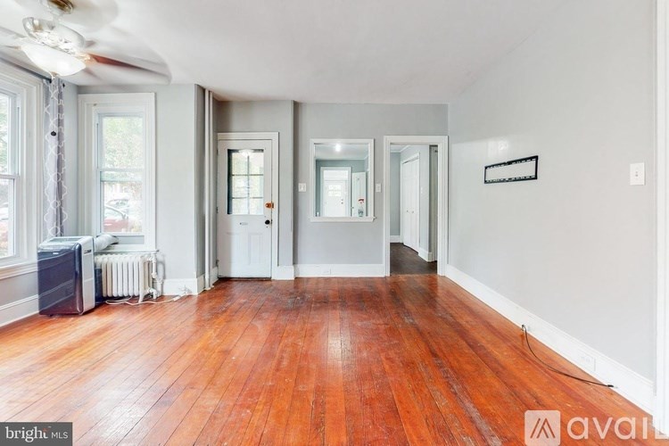 A room with wooden floors and white walls.