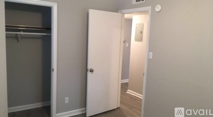 A white door is open to a hallway.