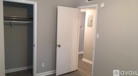 A white door is open to a hallway.