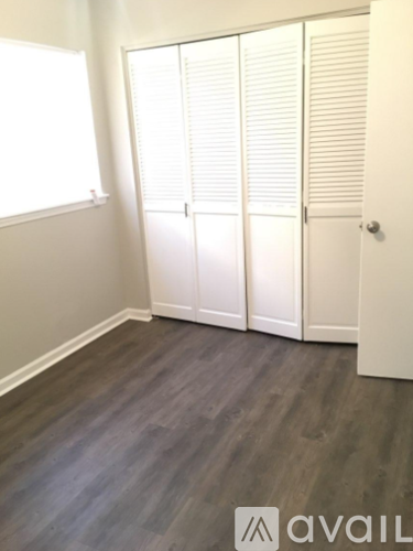 A room with a wooden floor and white walls.