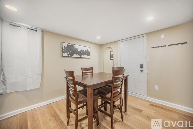 A dining room with a wooden table and chairs.
