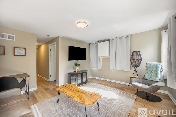 A living room with a wooden coffee table and grey couch.